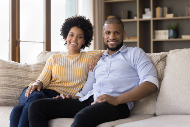 happy millennial african american couple of homeowners - koppel fotos stockfoto's en -beelden