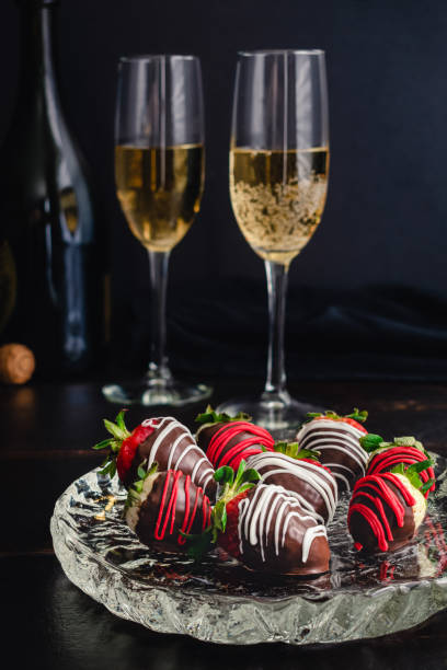 fragole e pinebere ricoperte di cioccolato con champagne - champagne pink strawberry champaigne foto e immagini stock