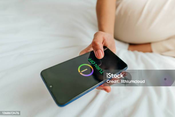 Close Up Of Female Hand Turning Off The Smartphone Stock Photo - Download Image Now - Turning On Or Off, Telephone, Mobile Phone