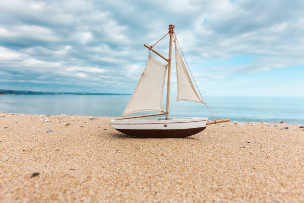 Sailing boat on the sandy beach of Golden Sands in Bulgaria Sailing boat on the sandy beach of Golden Sands in Bulgaria toy boat stock pictures, royalty-free photos & images