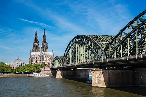 The Cologne Cathedral with Hohenzollern Bridge and Rhine River in Germany