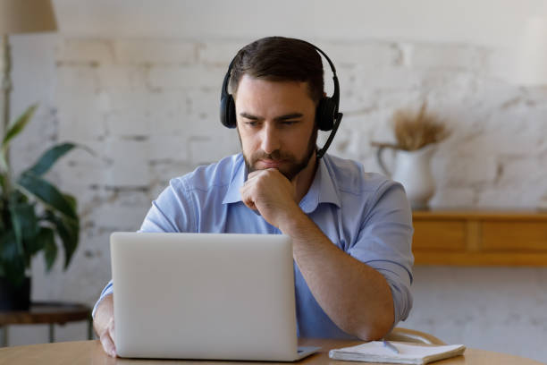 istock Concentrated young man holding video call meeting. 1368615011
