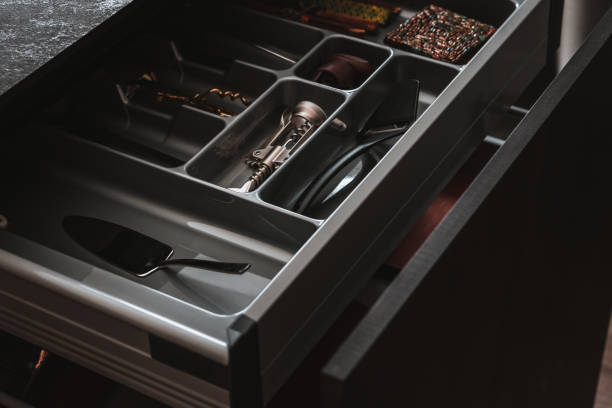 istock Modern kitchen. Open drawers with kitchenware and utensil. Soft closing inner drawer ideas. 1368615451