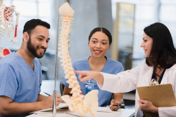 istock Medical students smile when professor helps them with classwork 1368615571