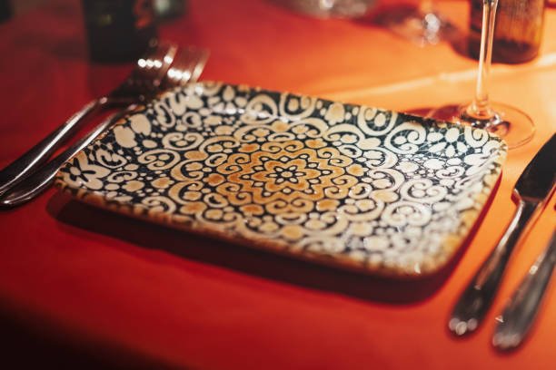 Nicely served table with red tablecloth, beautiful decorated plate for snacks. Festive Valentine's day dinner for two at a Portuguese food restaurant.