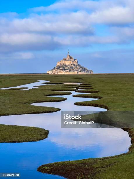 Salt Marsh And Mont Saintmichel Landscape In Normandy During Sunny And Cloudy Day Unesco World Heritage Site In France Europe Stock Photo - Download Image Now