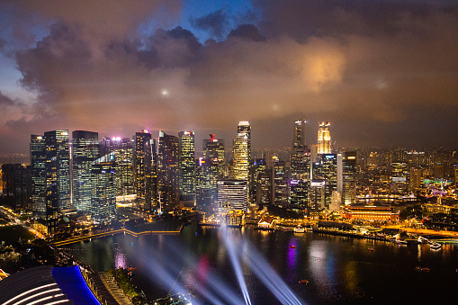 View over the city of Singapore during a nice summer night. The vibrant city turns into a light show in a spectacular fashion