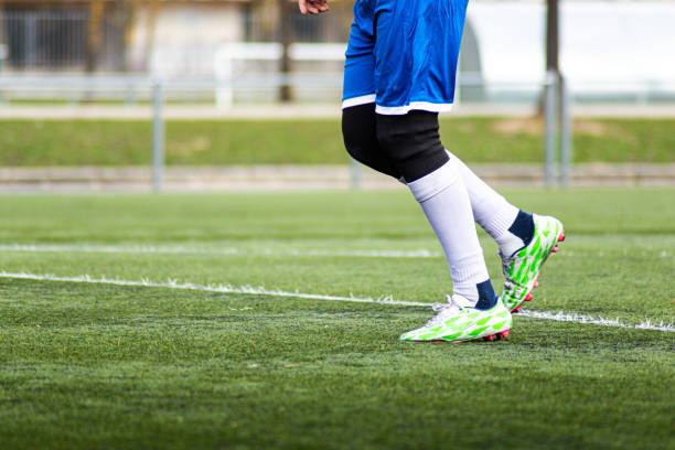 soccer player legs with white socks uniform and blue pants