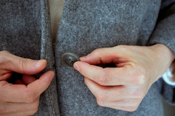 istock close-up of a person buttoning his jacket 1368619850
