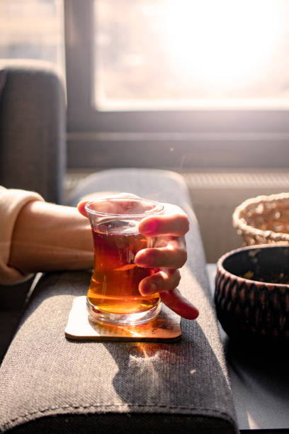 istock The lady drinking Turkish tea in a thin-waisted glass cup. black tea. 1368619878