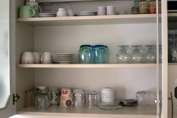 istock utensils for daily use lined up on the kitchen cabinet shelf. 1368620530