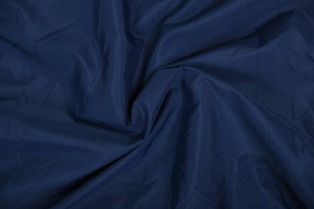 istock Blue fabric texture, background. folds close up. classic blue pantone 1368622974