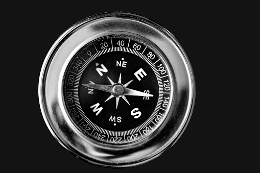 silver compass isolated on black background