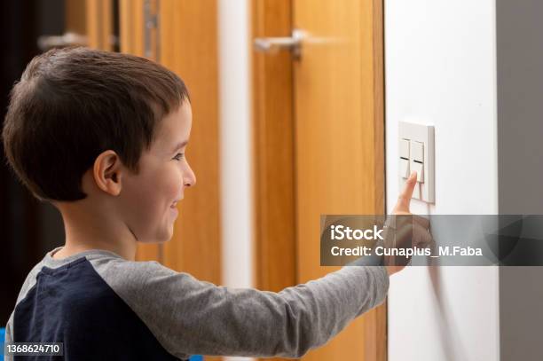 Little Boy Switching A Light Off Stock Photo - Download Image Now - Lighting Equipment, Turning On Or Off, Child
