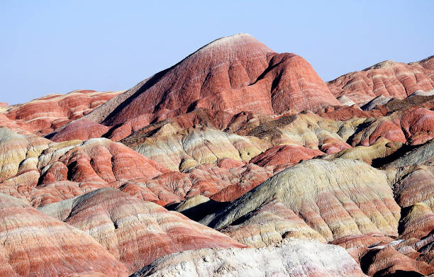 Mountain of Colors, Zhangye Danxia National Geological Park in the Gobi Desert, China One of the most spectacular natural wonders on the planet is located in the Gobi Desert, near China's border with Mongolia. The so-called "Zhangye Danxia National Geological Park / Pink Clouds" declared "World Heritage", is a pictorial work of nature in which an important extension of mountains show different colors as if a brush had been used. They are landscapes developed in continental red terrigenous sedimentary layers influenced by endogenous forces (such as elevation) and exogenous forces (such as wear and erosion). zhangye danxia geopark china stock pictures, royalty-free photos & images