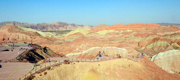 Mountain of Colors, Zhangye Danxia National Geological Park in the Gobi Desert, China One of the most spectacular natural wonders on the planet is located in the Gobi Desert, near China's border with Mongolia. The so-called "Zhangye Danxia National Geological Park / Pink Clouds" declared "World Heritage", is a pictorial work of nature in which an important extension of mountains show different colors as if a brush had been used. They are landscapes developed in continental red terrigenous sedimentary layers influenced by endogenous forces (such as elevation) and exogenous forces (such as wear and erosion). zhangye danxia geopark china stock pictures, royalty-free photos & images