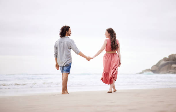 istock Shot of an affectionate couple taking a stroll on the beach 1368626038