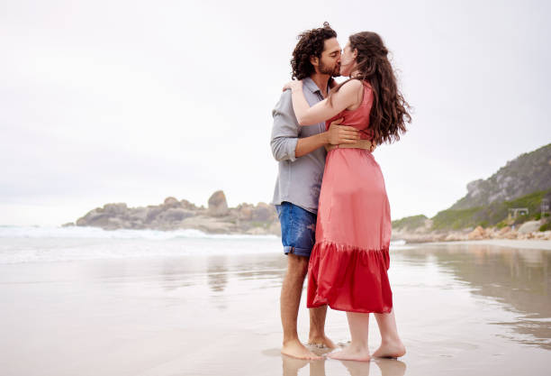 istock Shot of an affectionate couple spending time together at the beach 1368626042