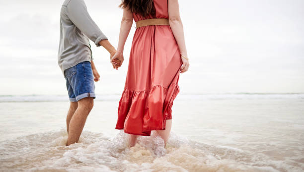 istock Shot of an affectionate couple taking a stroll on the beach 1368626049