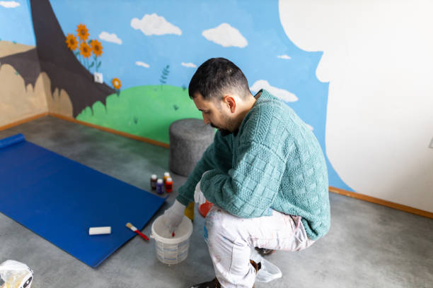 Caucasian male artist preparing the painting tools for work