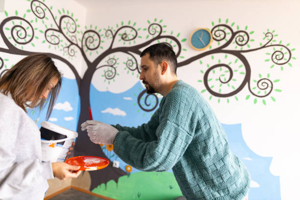 istock Dedicated female and male artist preparing paint and their tools for work 1368632249