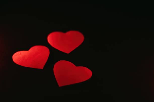 istock Paper hearts on black background 1368633085