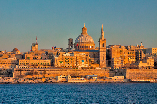 Malta - Valetta - The valetta's cityscape at dusk with harbor waterfront and our lady of mount carmel (madonna tal-karmnu) catholic church. taken from sliema