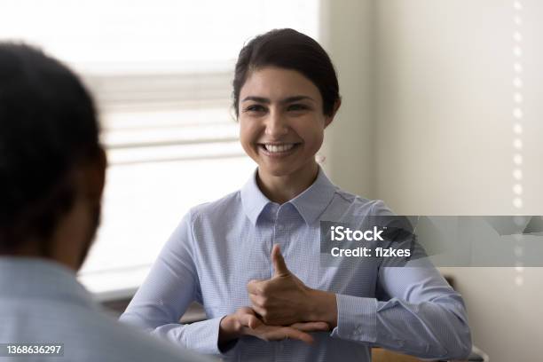 Smiling Young Indian Woman Who Is Deaf Using Sign Language Stock Photo - Download Image Now