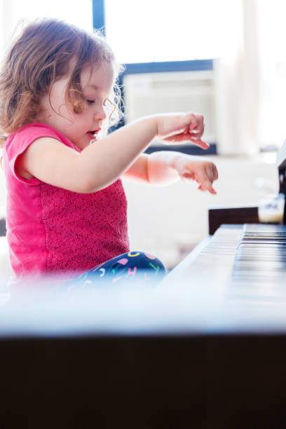 Baby Girl Playing Piano in the living room