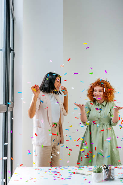 istock Two young women having fun in the office 1368637420
