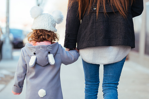 Mother and Daughter Walking together holding hands