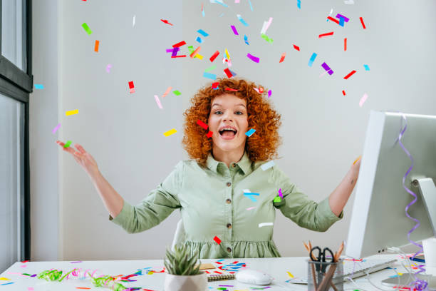 istock Young business woman having fun time catching confetti 1368637711