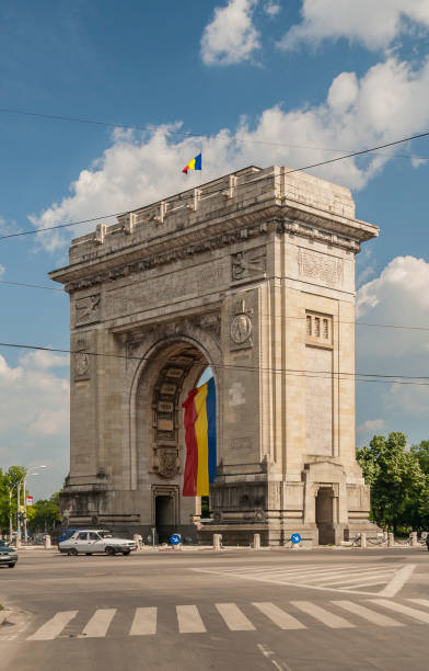 istock Triumphal arch with romanian national flag. Bucharest, Romania 1368640357