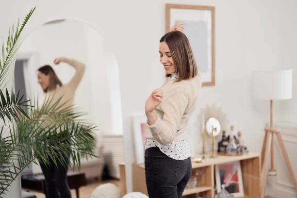 istock Beautiful young woman dancing joyful at home 1368641177