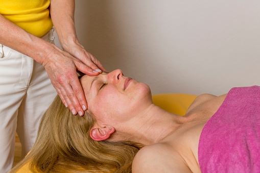 woman enjoying therapeutic massage in spa