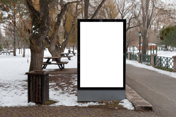 istock Blank billboard in snowy weather in a public park 1368643263