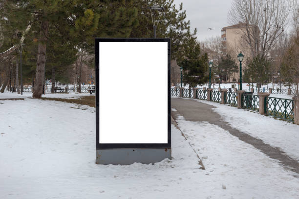 istock Blank billboard in snowy weather in a public park 1368643264