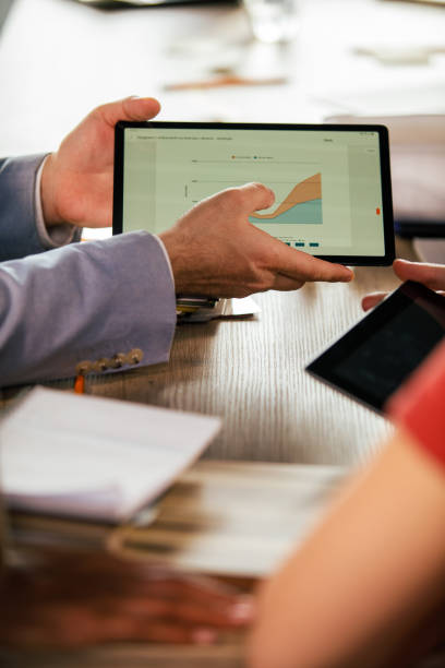 istock Businessman showing his colleagues chart on a digital tablet 1368644530