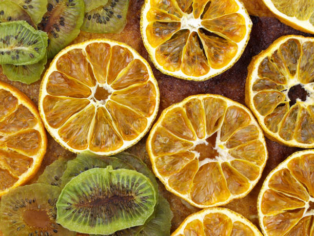 istock Dried sliced oranges and kiwi top view background. Dried citrus 1368644725
