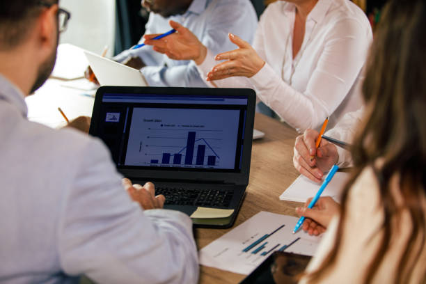 istock Business people reviewing data on laptop and documents during a meeting 1368645199