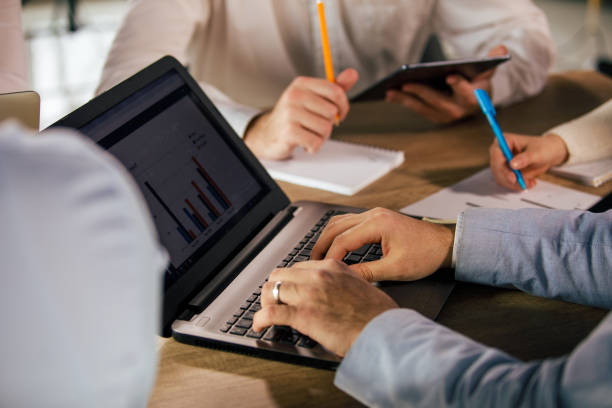 istock Unrecognizable businessman using laptop during a meeting 1368645225