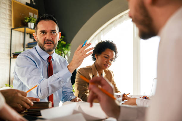 istock Male architect sharing his idea with a colleague during a meeitng 1368646057