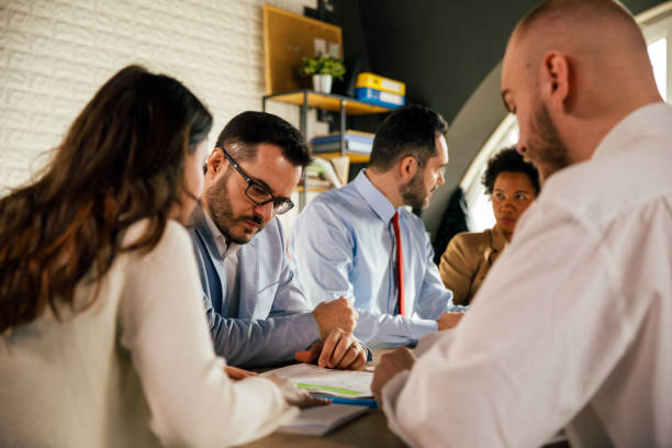 istock Serious group of architects working hard on designing a project 1368646082
