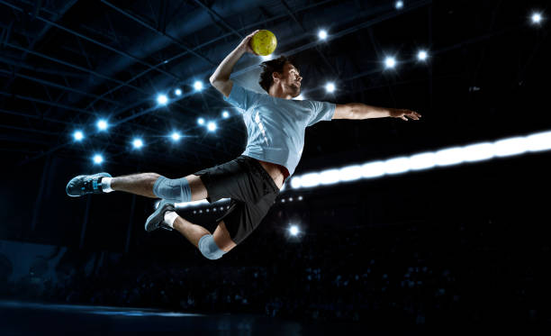 Handball player players in action Handball player players in action. Sports banner. Attack concept with copy space handball stock pictures, royalty-free photos & images