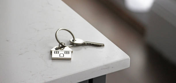 New Home A keyring with house key. keyring charm stock pictures, royalty-free photos & images