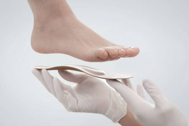 Orthopedic insole isolated on a white background. Hands in rubber gloves hold an orthopedic insole. Foot care, comfort for the feet. Doctor orthopedist tests the medical device. Flat feet correction Orthopedic insole isolated on a white background. Hands in rubber gloves hold an orthopedic insole. Foot care, comfort for the feet. Doctor orthopedist tests the medical device. Flat feet correction. pes planus stock pictures, royalty-free photos & images
