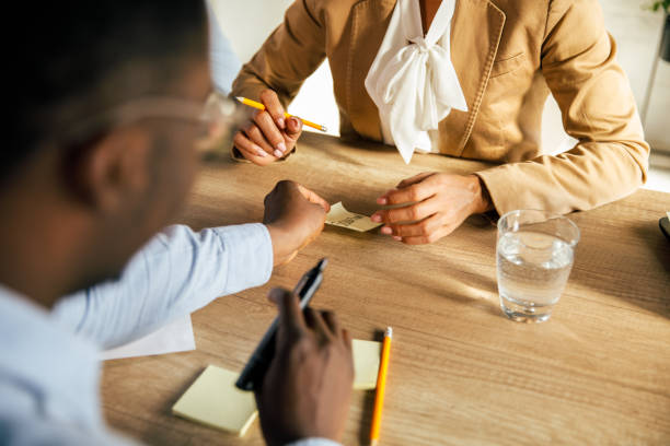 istock Businessman sharing a sticky note with a female colleague 1368649207