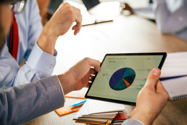istock Businessmen reviewing a chart on digital tablet during a corporate meeting 1368649228