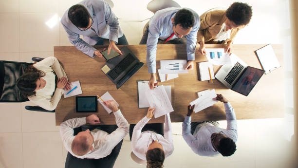 istock Business people exchanging documents during a corporate meeting 1368649242
