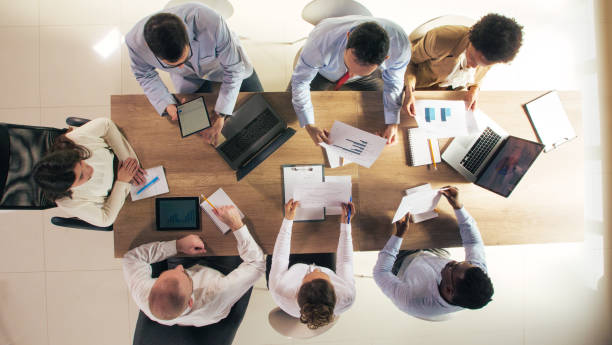 istock Business team reviewing graphs during a corporate meeting 1368649256